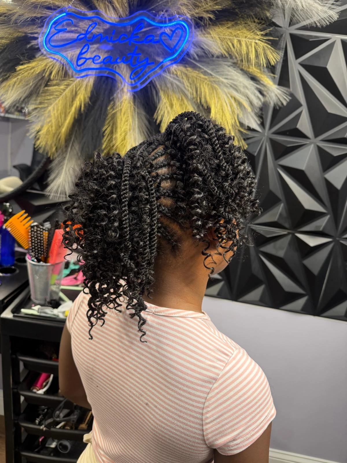 Patterned braids with loose curls, viewed from behind